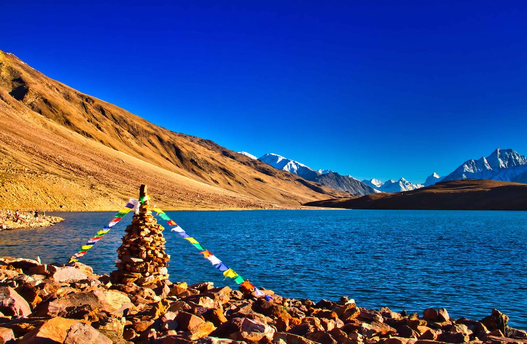 An ovoo with lung-tas on the banks of the lake An ovoo with lung-tas on the banks of the lake