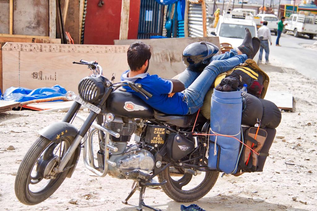 A motorcyclist takes a break A motorcyclist takes a break