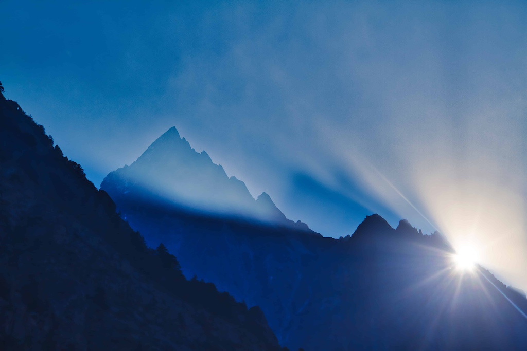 The sun finally breaks from behind a mountain The sun finally breaks from behind a mountain