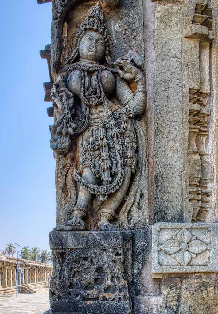 A dancer stands at the corner of the Andal Temple