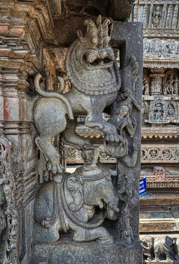 An intricate sculpture of a fight with a tiger from an elephant