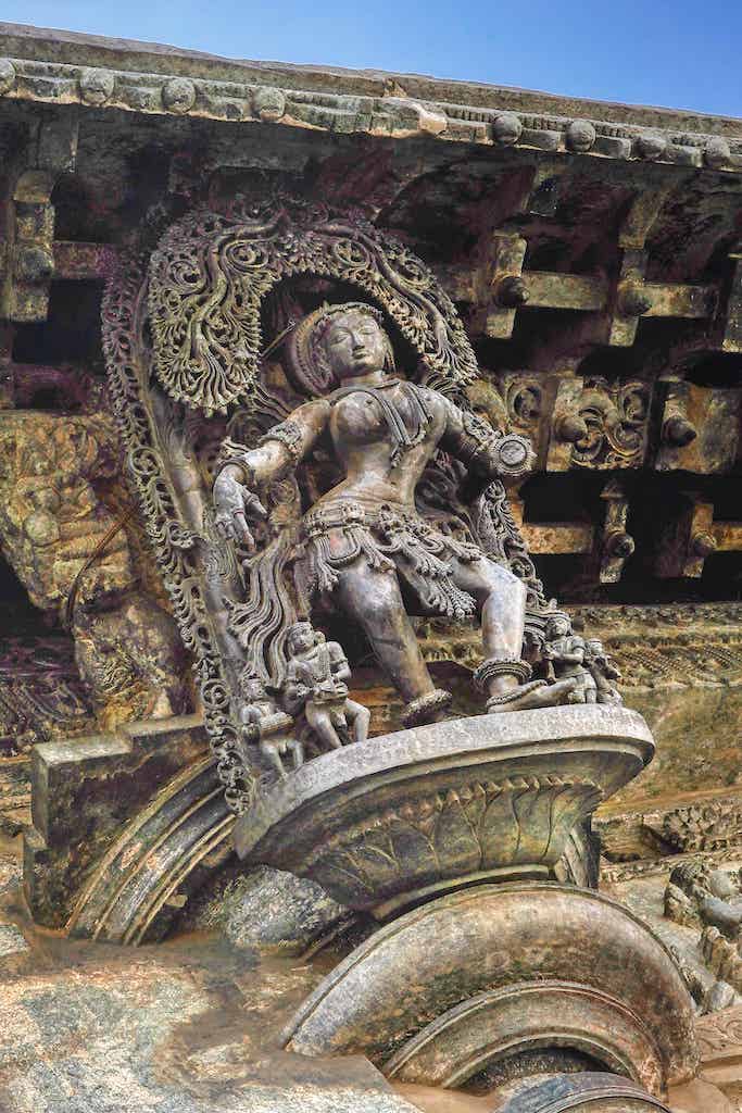 The exquisitely delicate carving of the tree cover over a madanika figurine