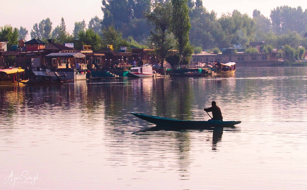 A shikara rows across in the late evening